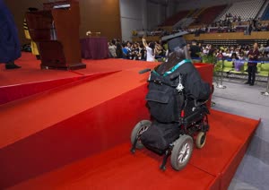 6:binary?id=aVUEm_2B2zKot4lRhOc8NwCbvTY_2BQYDxJwWS4lSZLOZdc8spj_2FcjkJSeKXMu8uo4C0:This year UM set up wheelchair ramps by the stage to facilitate graduates with disabilities 